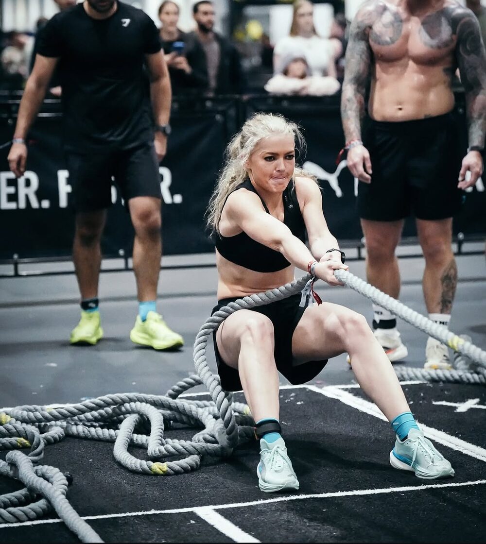 Hyrox athlete pulling the rope sled at a competition