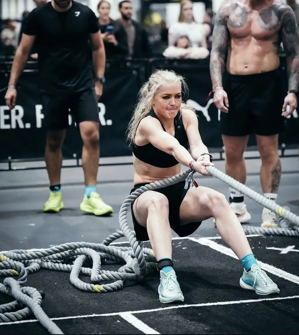 Hyrox athlete pulling the rope sled at a competition